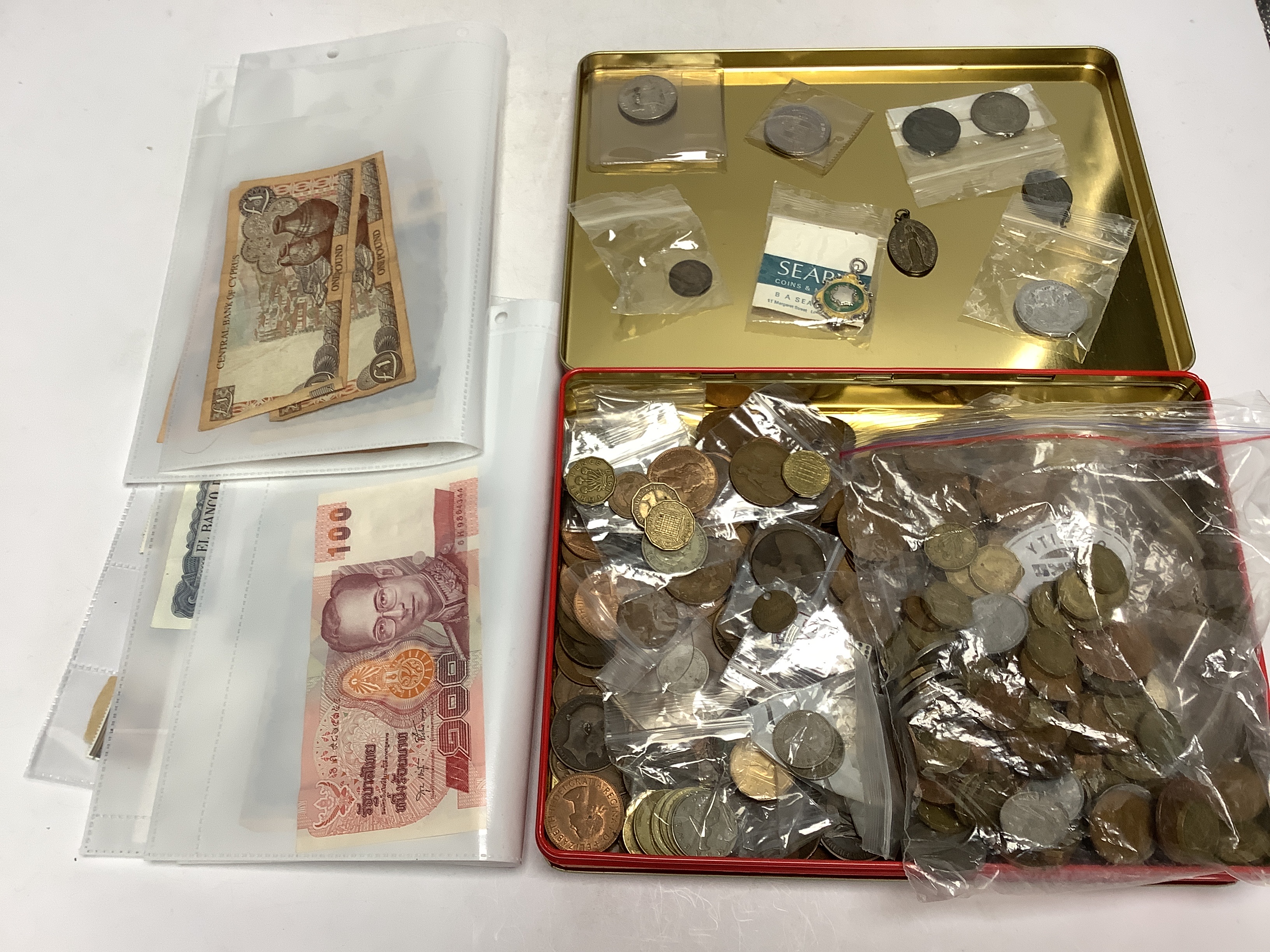 British coins, various models and bank notes, to include George V to QEII Florins, threepence, pennies, a silver and enamel football medal, German and Indonesian banknotes etc.
